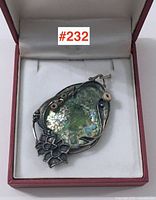 Full view of signed pendant in box