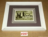 Framed print showing architectural buildings in a white frame with a double mat in cream and mauve.
