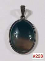 Front view of the sterling silver pendant showcasing the polished oval stone and the bail.