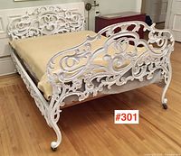 Angled overall view of bed showing headboard, footboard, side rails and casters