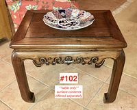 Front view showing the recessed panel top, carved apron and leg design