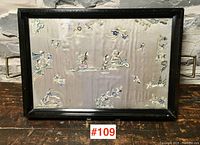 Full front view of the vintage serving tray showing the black wooden frame, brass handles, and the Chinese silk embroidery under glass with traditional motifs.