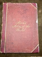 Front cover view of red leather boards with gold embossed title