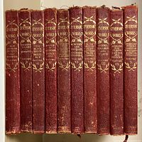 Front view of the complete set of 10 volumes of Robert Louis Stevenson works, showing red leather spines with gold embossed titles and decoration.