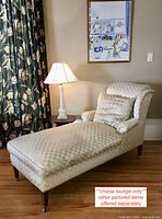 Side view of full chaise longue showing overall shape, upholstery and wooden caster legs