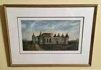 Framed print image showing entire print and frame, depicting a castle with multiple peaked turrets under a cloudy blue sky.