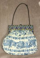 Full front view of purse showing frame, body, and strap