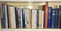 Full shelf view showing approximately two dozen mixed-size books on history and architecture