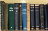 Books lined up on a shelf showing titles and condition