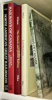 Five vintage railway books on a bookshelf with visible titles and authors, showing colors and condition of spines and jackets.