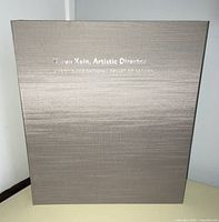 Gray textured slipcase front with silver foil title