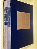 Two cloth-bound volumes in slipcase on shelf