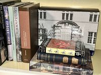 Shelf with nine Canadian-themed books including history, culture, architecture and vintage bindings.