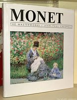 Front cover of large art book titled "Monet The Masterworks / Jean-Paul Crespelle" with a color image of a woman and child in a garden.