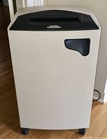 Front view of floor-standing shredder showing feed slot and front access panel
