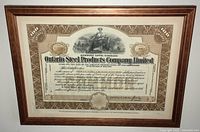 Full front view of framed stock certificate showing entire document and frame.