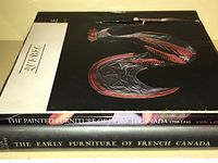 Photo showing the spines of three books including 'The Painted Furniture of French Canada', 'The Early Furniture of French Canada', and part of the 'Quebec' book cover.