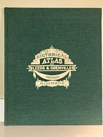 Front cover showing green cloth binding and gilt stamped title 'Historical Atlas of Leeds & Grenville Ontario Illustrated'