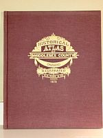 Front cover of the hardcover atlas book with maroon cloth and gold embossed lettering.