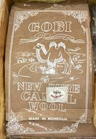 Image showing original packaging with label 'GOBI New Pure Camel Wool Made in Mongolia' and camel design.