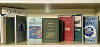 Books on shelf with titles related to Quebec history and culture, showing spines and covers