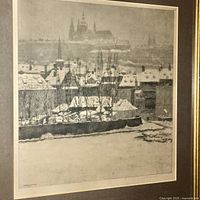 Close-up of the signed print showing detailed winter cityscape with buildings and trees.