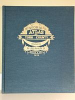 Front cover of the book with blue cloth and gilt embossed title.