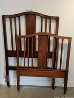 Antique solid oak bed headboard and footboard with vertical slats, chevron wood inlay panel, curved tops, and custom bed rails.