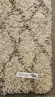 Close-up of carpet pile texture showing plush grey taupe cream melange fibers and Still Hill Lot 132 tag.