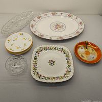 Overview of assorted china including Royal Albert platter, Grafton plate, German saucer, crystal dishes, and side plates.