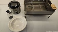 Photo of the countertop dish drainer, rice cooker, salt or pepper grinder, and one white Royal Doulton bowl on white surface.