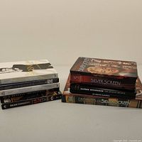 Photo showing all DVD sets stacked together, including 007 Sean Connery titles and multiple Silver Screen and Alfred Hitchcock collections.