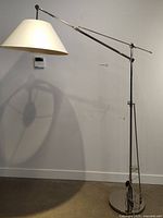 Full view of the floor lamp showing chrome finish, adjustable arm, and fabric shade