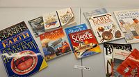 Photo displaying a selection of children's science books including 'Journey Through the Planets', 'Journey Through the Human Body', 'Mighty Machines', 'Sharks', and other educational titles.