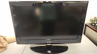 Samsung 37-inch TV front view showing black frame and oval base stand.