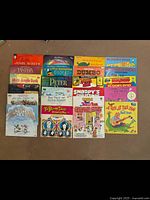 Photo showing 23 vintage children's vinyl records with titles including Disney classics, Scooby-Doo, Snoopy's Christmas, The Partridge Family, Sesame Street, and other animated and holiday-themed records.