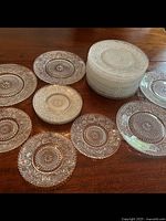 Full view of small and medium plates showing clear glass and cut glass floral and geometric pattern detail.