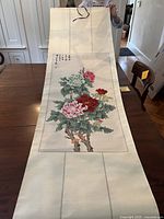 Full view of the hanging scroll displaying the flower painting with calligraphy and signature
