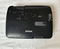 Top view of Epson EX50 digital projector showing buttons and model label.