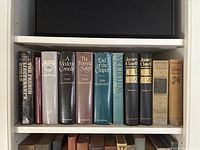 Shelf with classic hardcover novels featuring titles by John Galsworthy, James Clavell, and other notable authors.