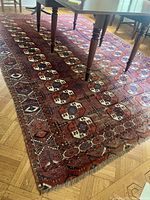 Overall view of red and white rug under dining table showing full field and pattern alignment