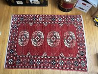 Full top-down view of the rug on a hardwood floor showing entire pattern and size
