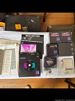 Overview of all Merlin Lettering System items including discs, manuals, packing slip, and papers laid out on white surface.