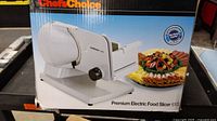 Photo of box with image of white Chef's Choice electric food slicer model 6102, showing product appearance and size.