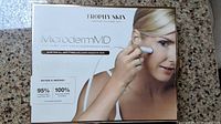 Box of Trophy Skin Microdermabrasion Machine showing branding and product image of handheld device used on face