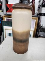 Side view of the ceramic vase showing gradation of brown and beige glaze.