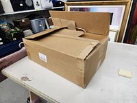 Closed cardboard box on a table.