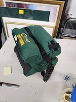Green padded carrying case with handle and branded 'Caldwell Tack Driver' in yellow print.