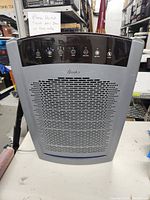 Front view of grey Hunter air purifier showing the front air intake grill and control panel.