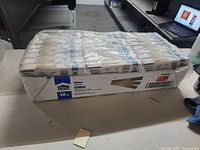 Full carton of Project Source shims in unopened boxes, shrink-wrapped together on a table.